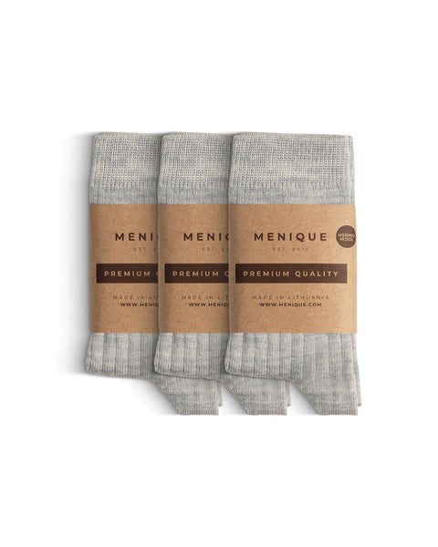A 3-pack of kids’ light gray ribbed merino wool socks with “Menique Premium Quality” labels.