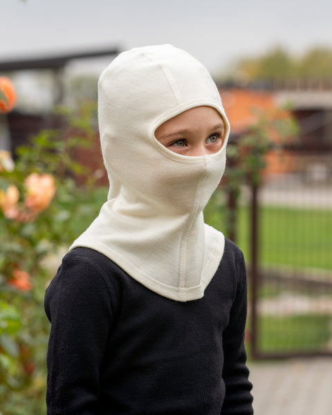 a girl wearing the merino 250gsm balaclava face mask in the color natural.