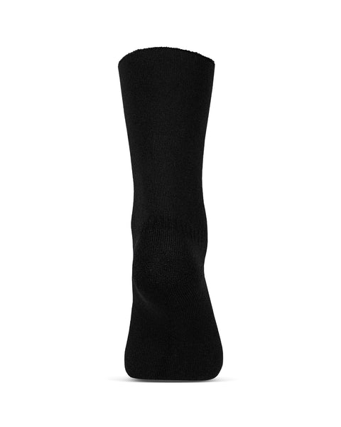 The menique women's merino lined sherpa socks in color black, in a white background, heel view.