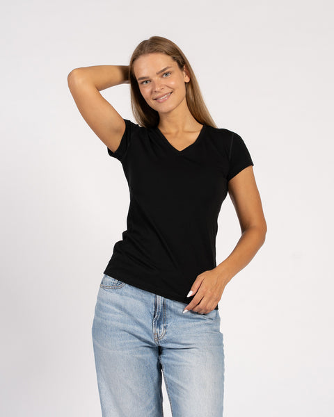 Woman posing in a black Merino wool V-neck T-shirt with short sleeves.