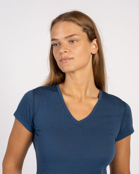 Close-up of a woman wearing a denim Merino wool V-neck short sleeve T-shirt.