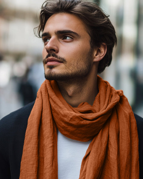 Man wearing an orange scarf with a blurred background
