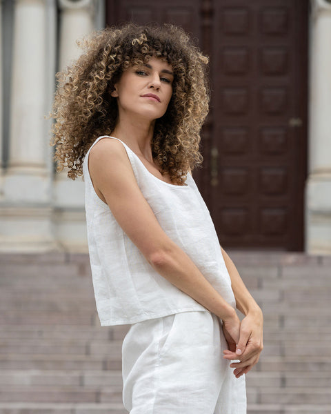 Woman standing outdoor and wearing Linen Sleeveless Crop Top Ana in Pure White color
