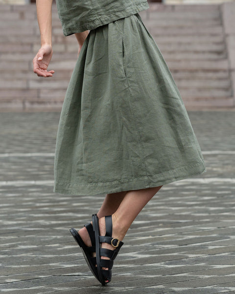 Woman wearing stone green linen skirt Sophia.
