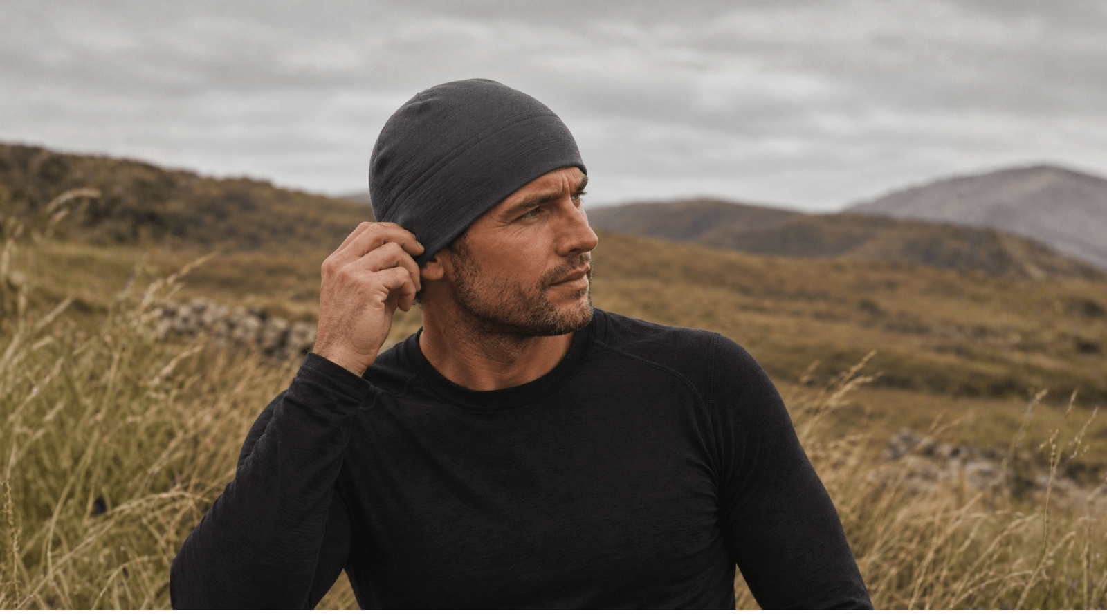 Man outdoors wearing dark green merino wool beanie