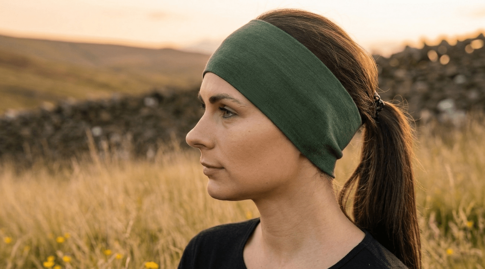 Woman outdoors wearing royal cherry merino wool headband.