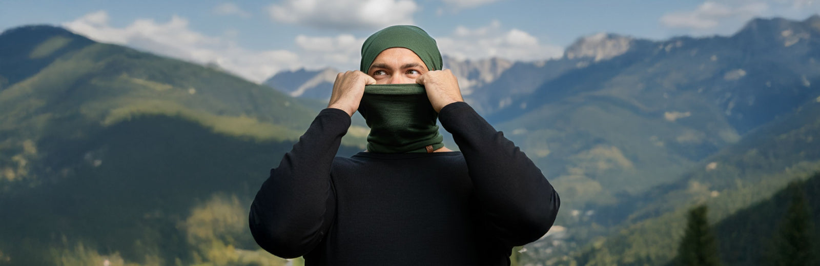 Person wearing a green headscarf with mountains in the background