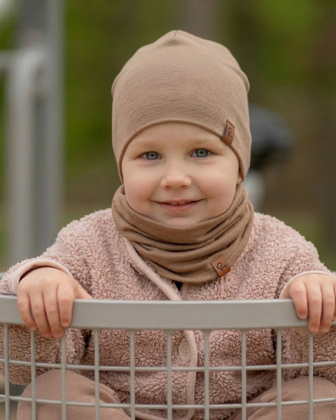 Child wearing beige merino wool beanie and neck gaiter set, soft breathable kids merino wool hat and neck warmer designed for outdoor play, temperature regulation, and everyday winter comfort.