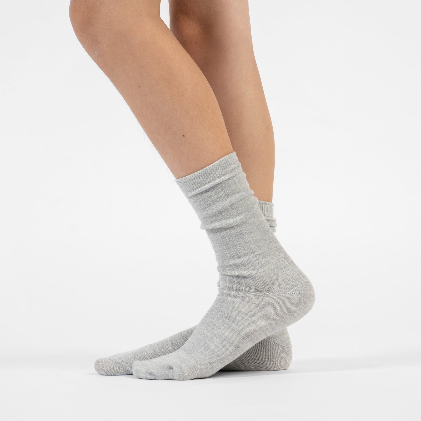 Six pairs of light gray thin ribbed kids’ socks, folded neatly and wrapped in Menique branded paper bands labeled ‘Premium Quality.
