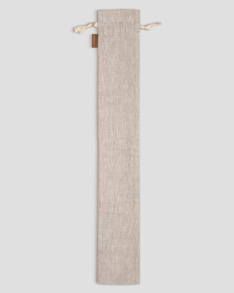 Natural linen fabric pouch with drawstring on a light gray background
