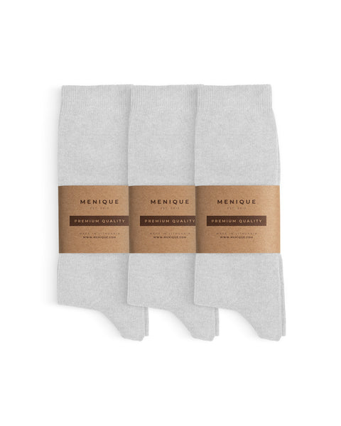 Three pairs of men’s white cotton socks, folded neatly and wrapped with Menique brown paper bands labeled ‘Premium Quality.