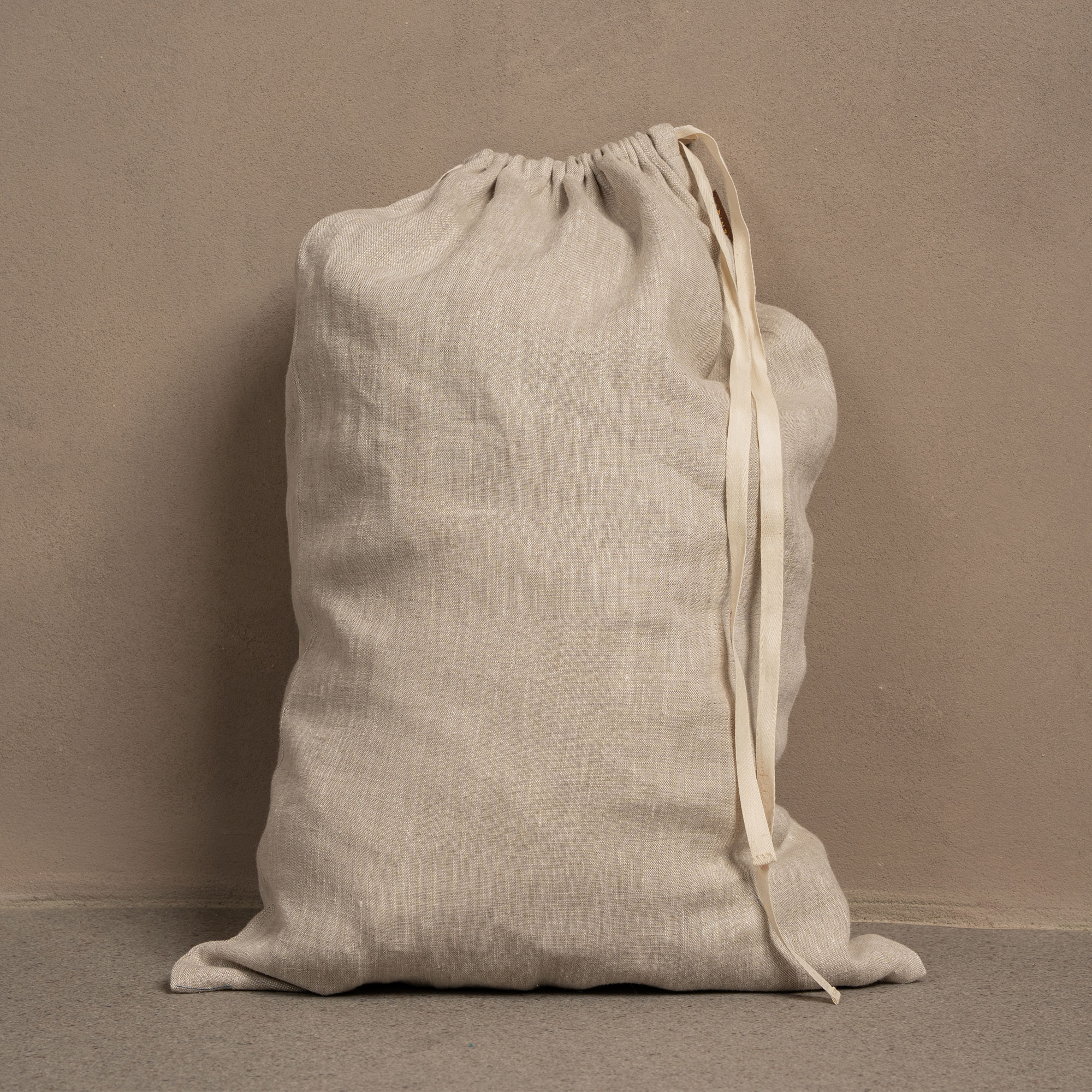 Linen laundry bag with white drawstrings