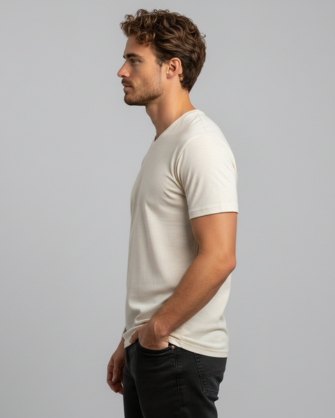 Front-facing view of man in beige Merino wool V-neck T-shirt with hands in pockets.