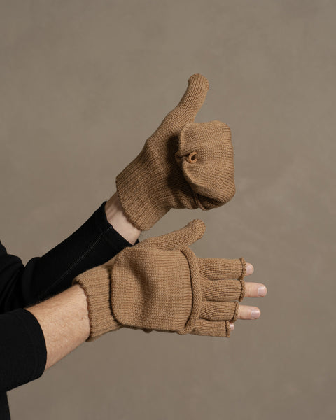 Hands wearing caramel brown merino convertible gloves, demonstrating adjustable warmth with flip-top mitten design.