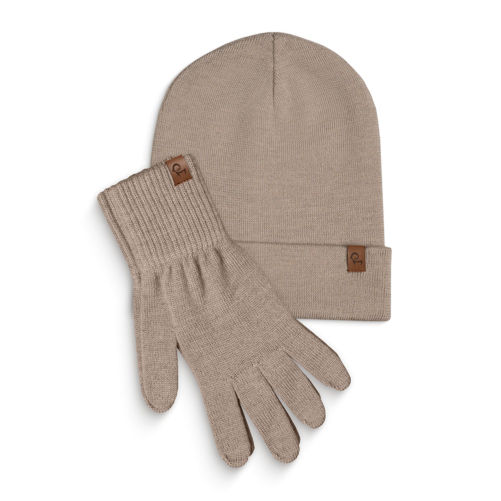 A dark gray knitted beanie and a pair of matching gloves are laid flat against a white background. Both the beanie and each glove have a small, rectangular brown leather tag with a menique logo on them. The items are slightly overlapping, with the beanie positioned above and to the left of the gloves.