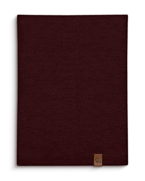 Royal cherry Merino wool knit neck gaiter shown flat with a leather logo tag.