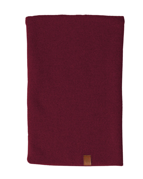 A royal cherry knit neck gaiter, likely made of merino wool, is displayed against a white background. The gaiter is shown laid flat and has a small brown tag at the bottom.