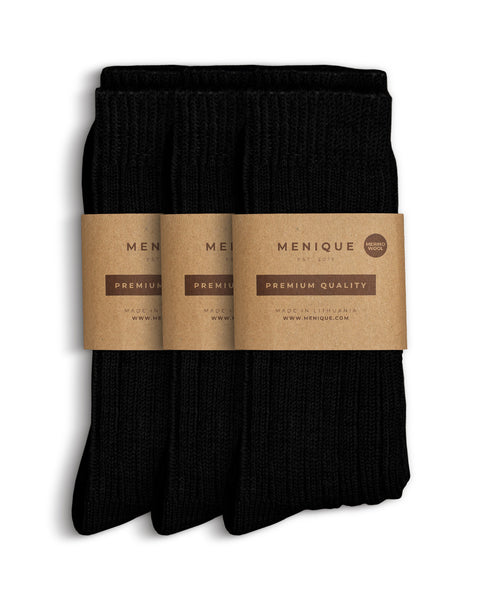 Set of three pairs of women’s black ribbed thick socks, wrapped in eco-friendly Menique kraft paper labels reading ‘Premium Quality – Merino Wool.