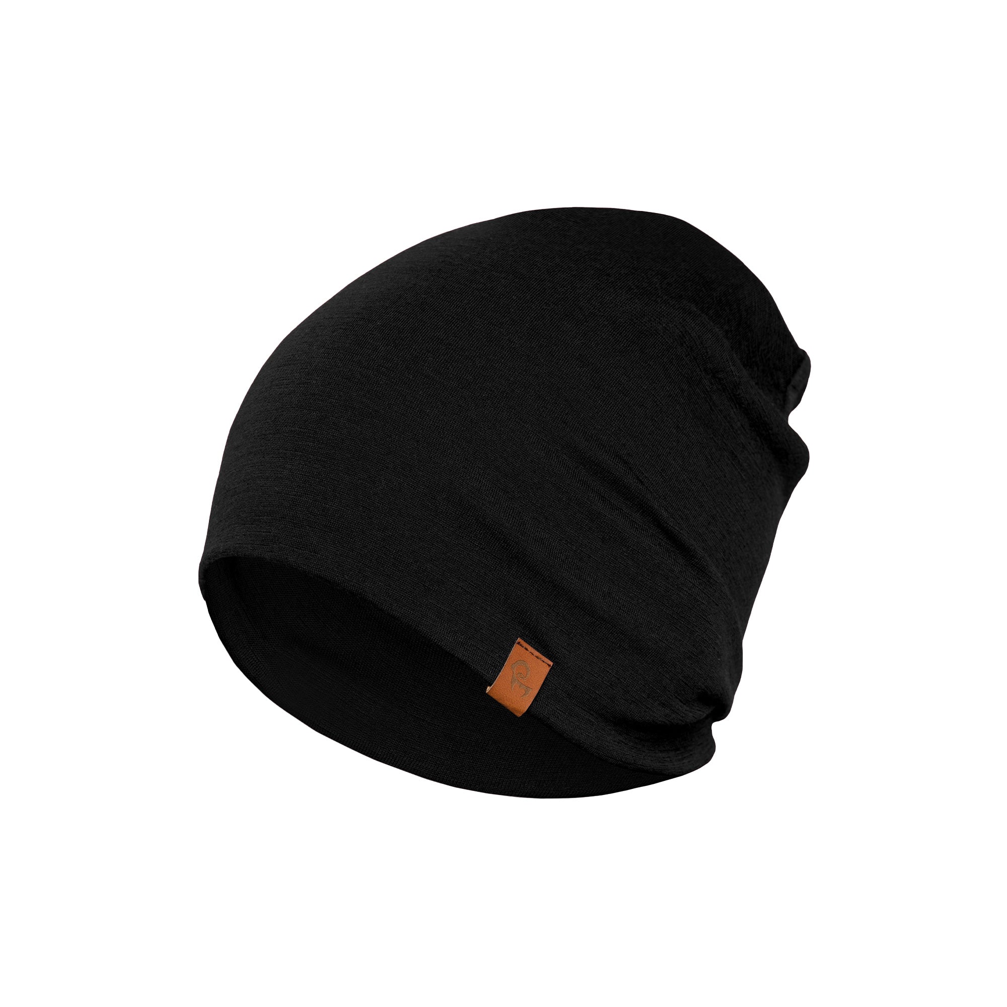 The Menique Men's Merino Beanie and Gaiter Set in Black color. The man is wearing the accessory set in a forest, in fall time.