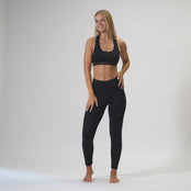 The menique women;s merino wool sport bra and leggings set in black color.