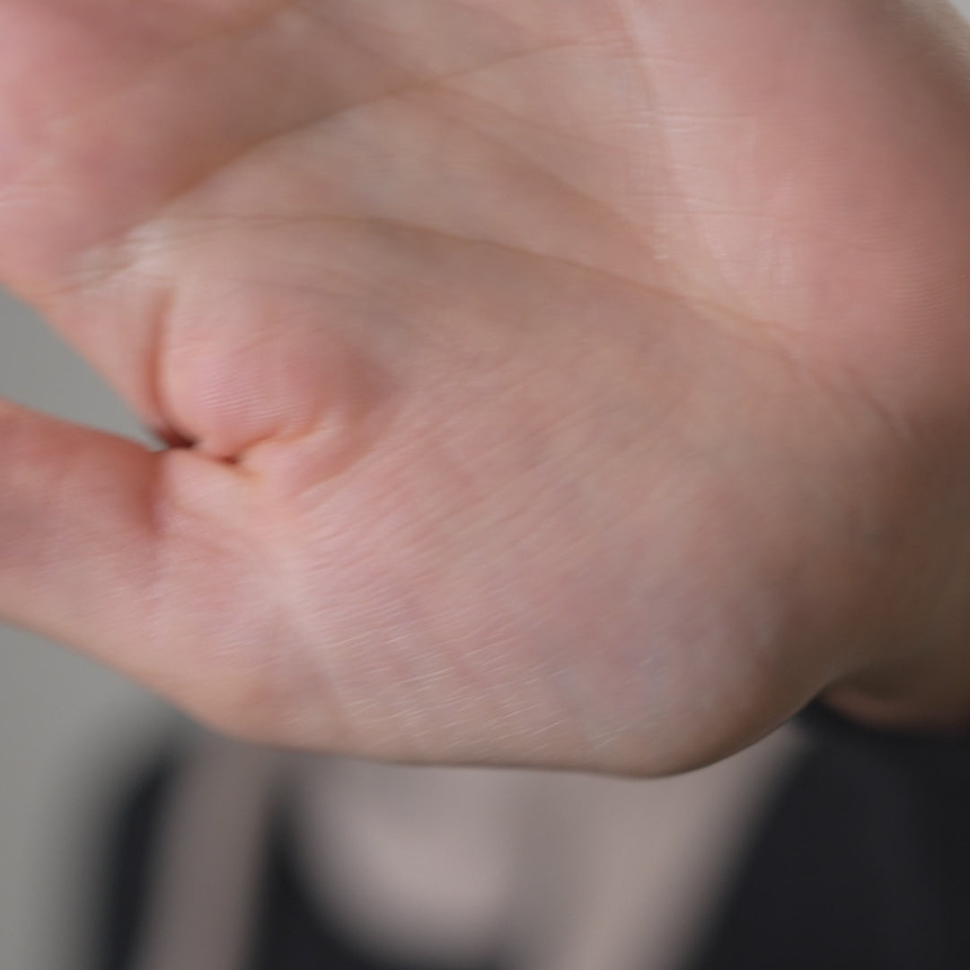 Video of a model wearing a merino wool knit bandana, highlighting bandana's design.
