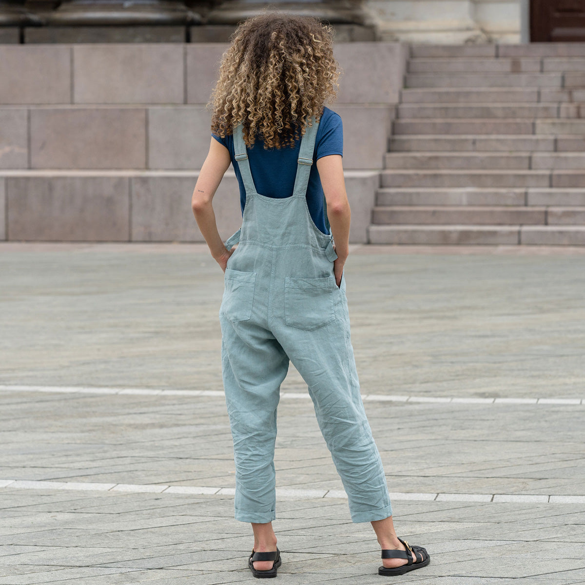 Gorgeous woman in a city, wearing mint green linen Jumpsuit Nicci.